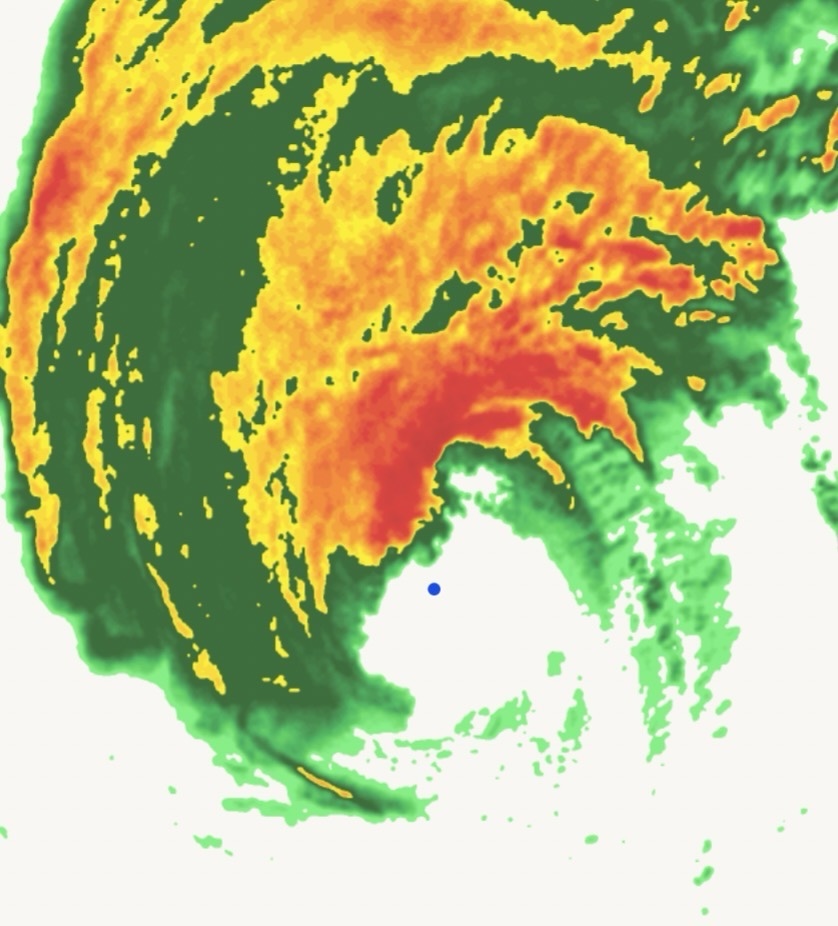 Satellite radar image of a hurricane's eye surrounded by dense storm bands