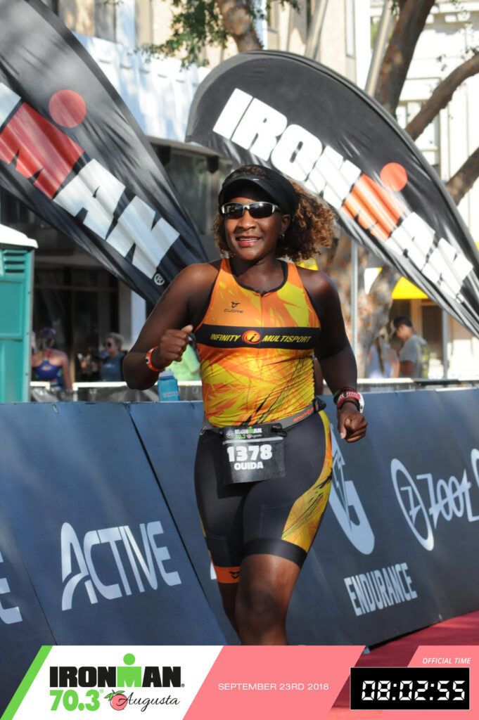 Runner crossing the finish line at an Ironman 70.3 triathlon